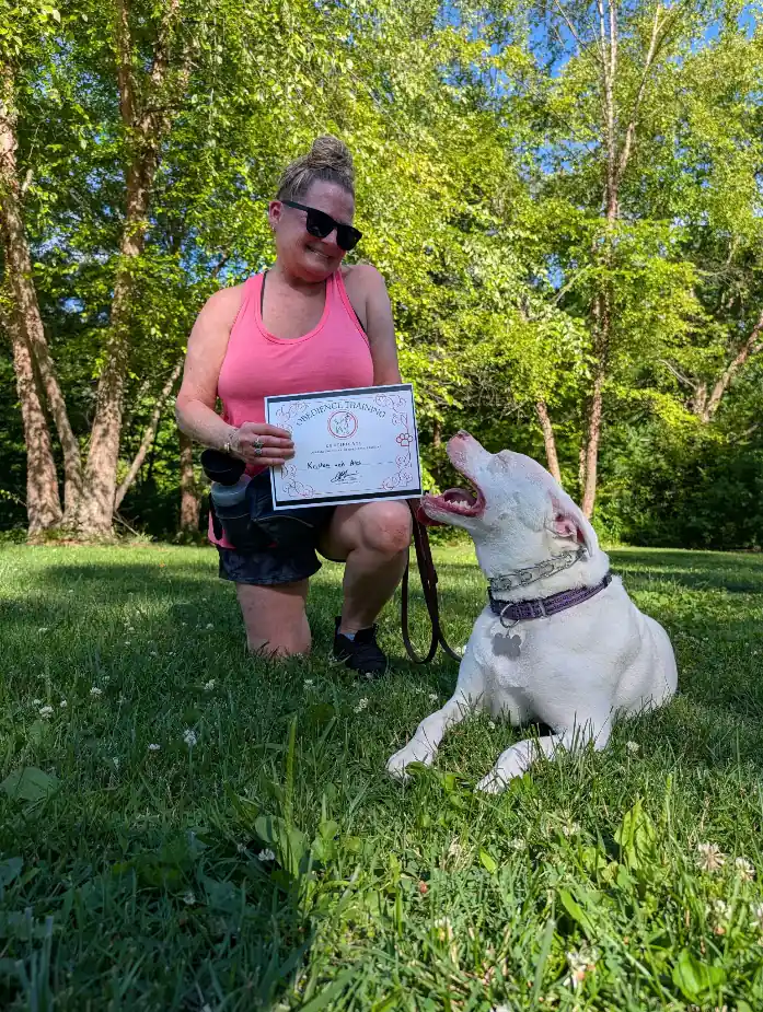 Kristin and Ares with their obedience training certificate